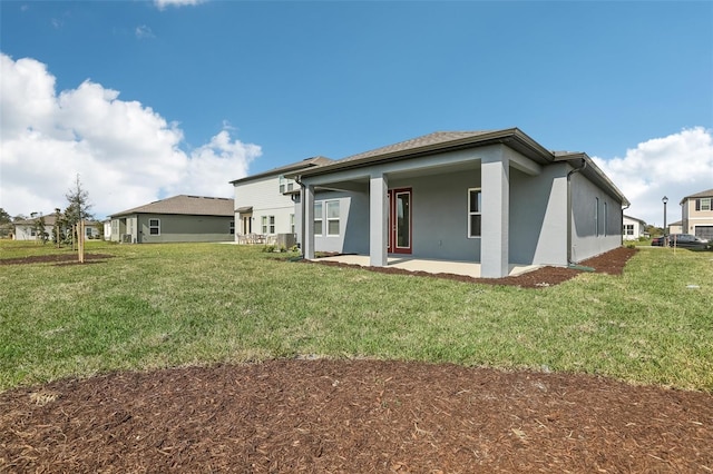 back of property featuring a yard and a patio