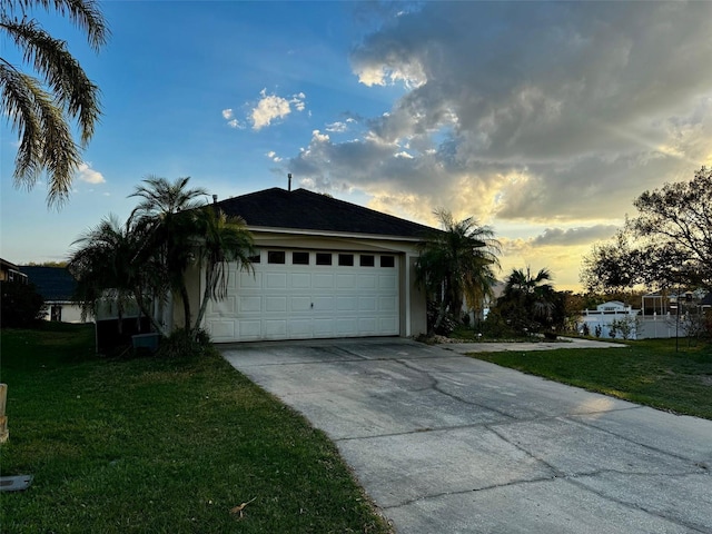 view of front facade with a garage and a lawn