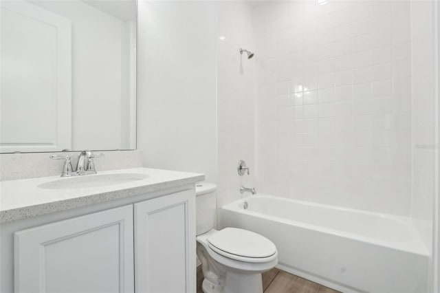 bathroom featuring tub / shower combination, vanity, toilet, and wood finished floors