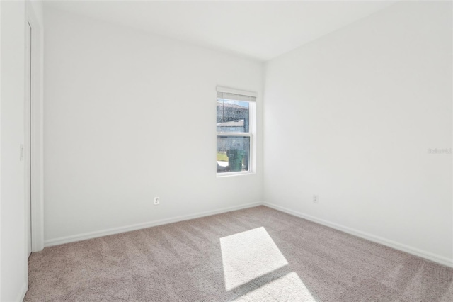 spare room with carpet floors and baseboards