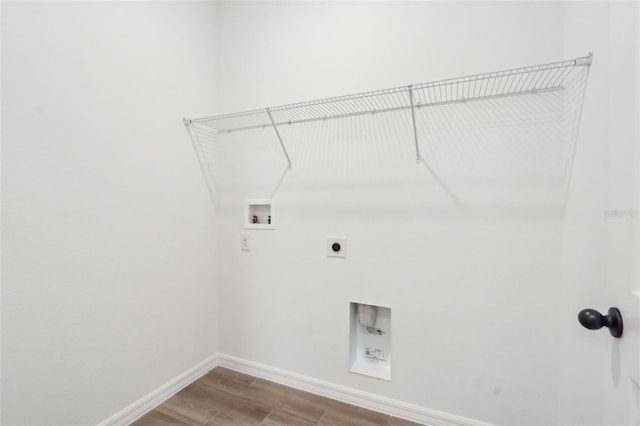 laundry room featuring hookup for a washing machine, hookup for an electric dryer, wood finished floors, laundry area, and baseboards