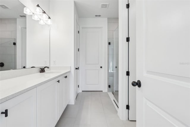 bathroom featuring vanity, a shower stall, and visible vents