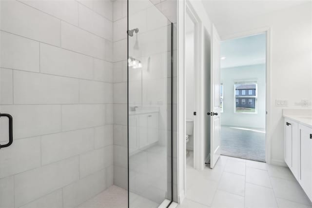 bathroom with toilet, a stall shower, tile patterned flooring, and vanity