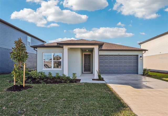 view of front of home featuring a garage, concrete driveway, a front lawn, and stucco siding