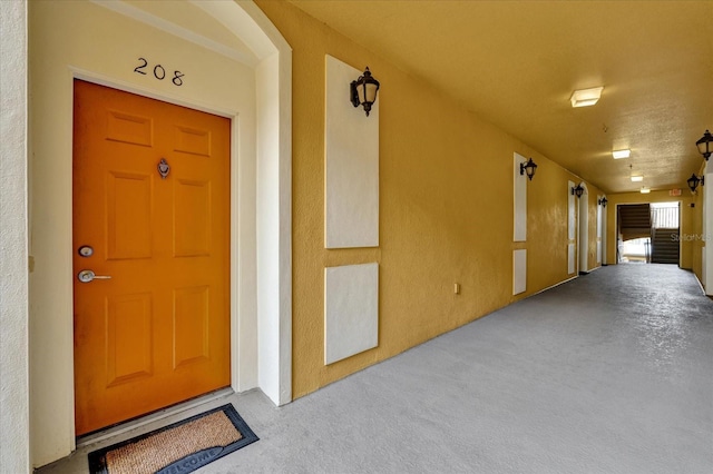 view of exterior entry with stucco siding