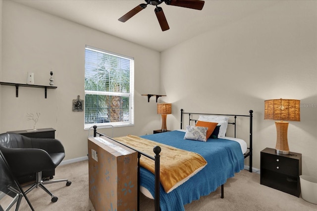 bedroom with light carpet, a ceiling fan, and baseboards