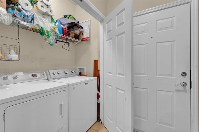 washroom featuring washing machine and dryer and light tile patterned flooring