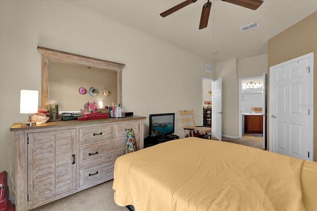 bedroom featuring light colored carpet, ceiling fan, connected bathroom, and visible vents