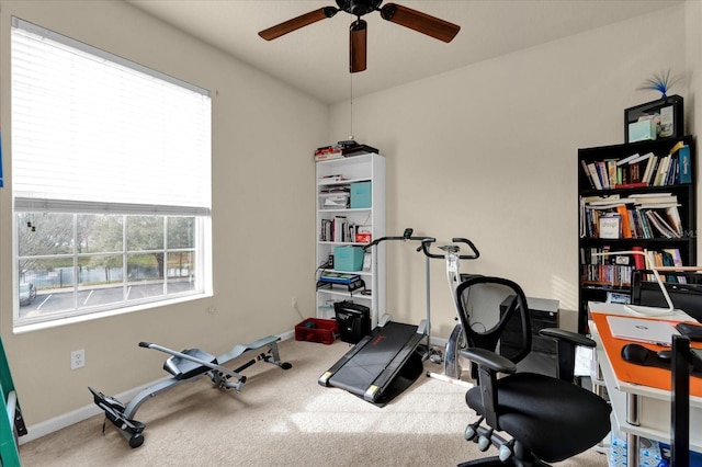 workout room with baseboards, carpet floors, and ceiling fan