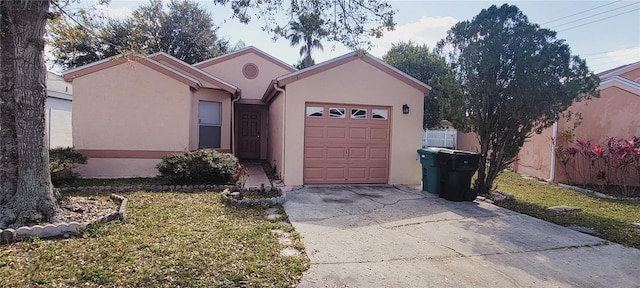 ranch-style house featuring a garage and a front lawn