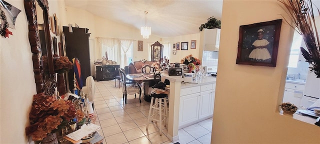 interior space featuring lofted ceiling, sink, and light tile patterned floors