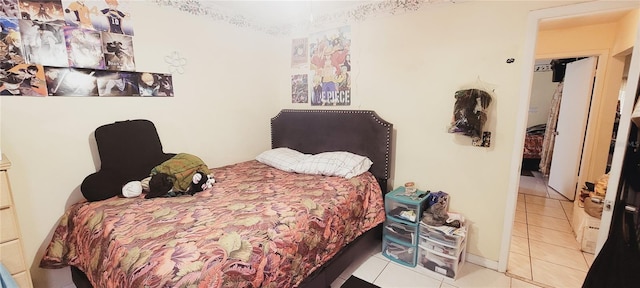 bedroom with light tile patterned floors