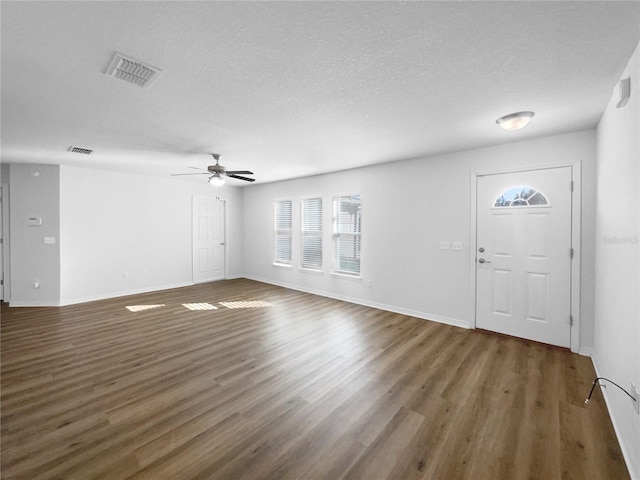 entrance foyer with dark hardwood / wood-style flooring, ceiling fan, and a textured ceiling