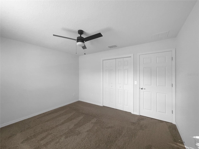 unfurnished bedroom with carpet, ceiling fan, and a closet