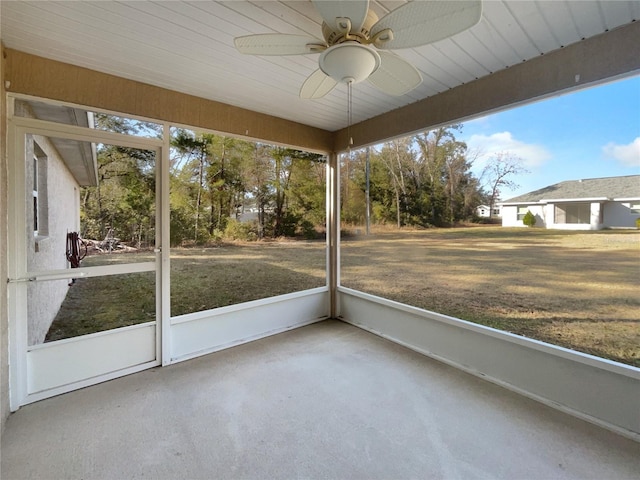 unfurnished sunroom featuring ceiling fan