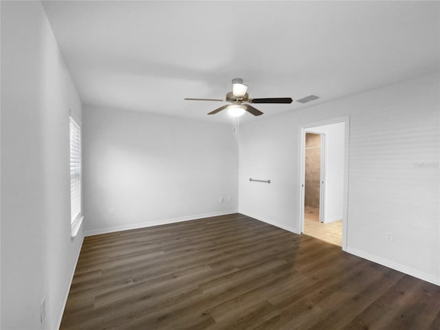 empty room featuring dark wood-type flooring and ceiling fan