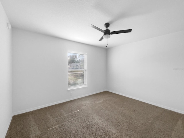 spare room featuring ceiling fan and carpet