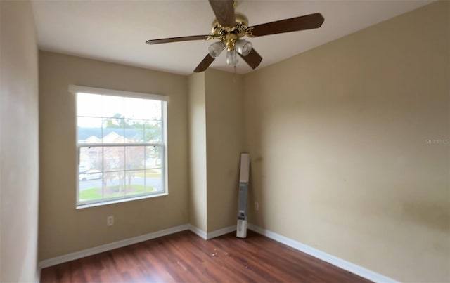 spare room featuring dark hardwood / wood-style floors and ceiling fan