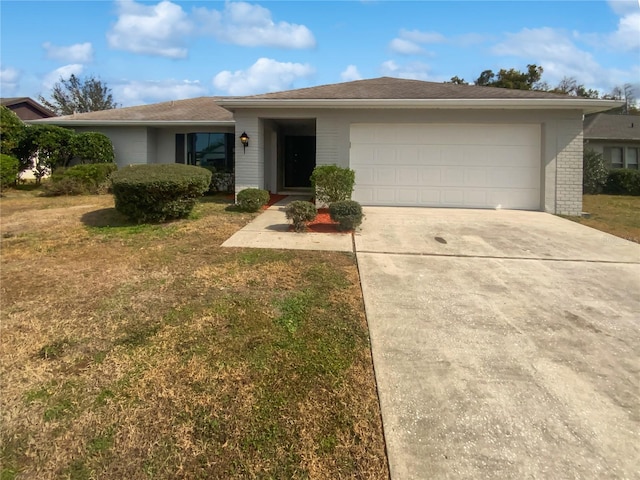 single story home with a garage and a front lawn