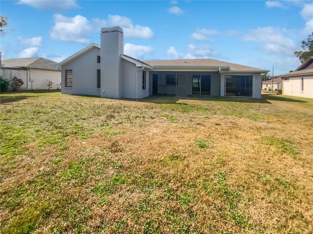 rear view of property with a yard