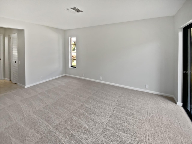 unfurnished room featuring light colored carpet