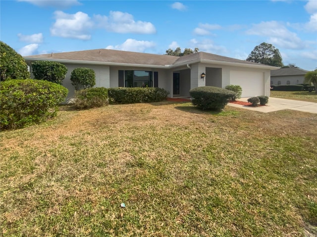 single story home featuring a garage and a front yard