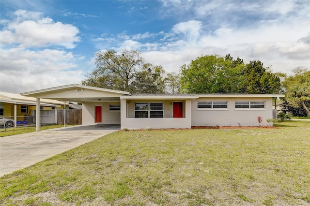 ranch-style house featuring a carport and a front yard