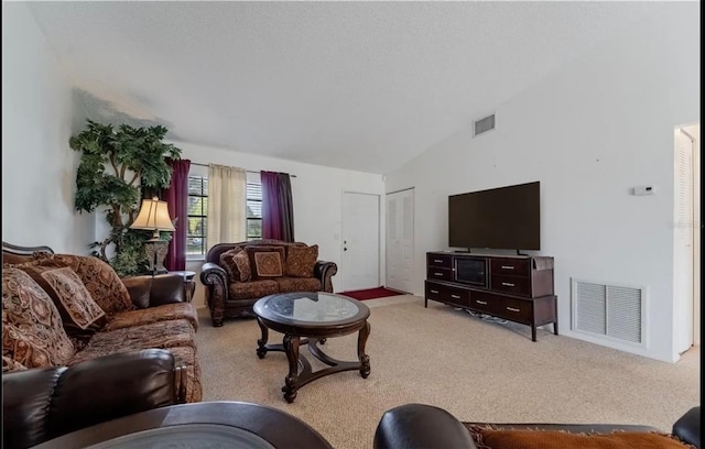 living area with light carpet, high vaulted ceiling, and visible vents