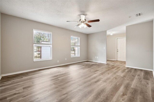 353 E Orange St, Altamonte Springs, FL 32701 - empty room with ceiling fan, hardwood / wood-style floors, and a textured ceiling