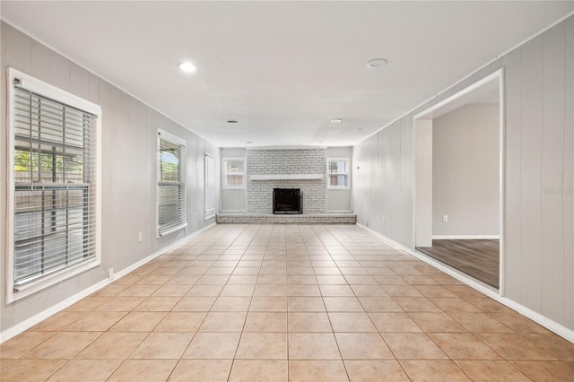 353 E Orange St, Altamonte Springs, FL 32701 - unfurnished living room featuring light tile patterned flooring and a brick fireplace