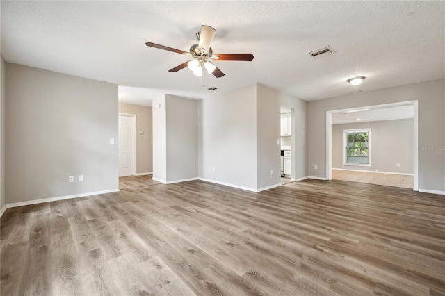 353 E Orange St, Altamonte Springs, FL 32701 - unfurnished living room with ceiling fan, wood-type flooring, and a textured ceiling