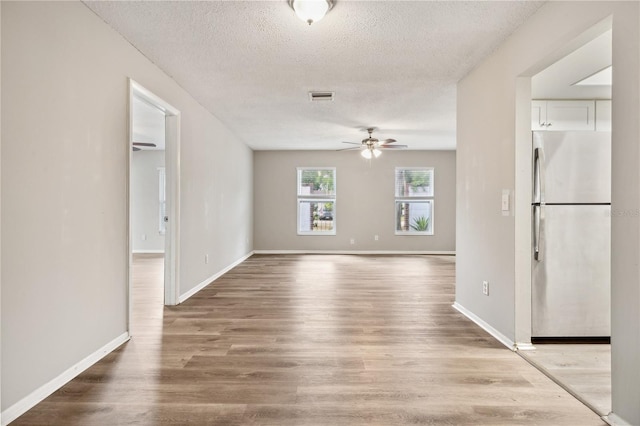 353 E Orange St, Altamonte Springs, FL 32701 - unfurnished room featuring ceiling fan, light hardwood / wood-style flooring, and a textured ceiling