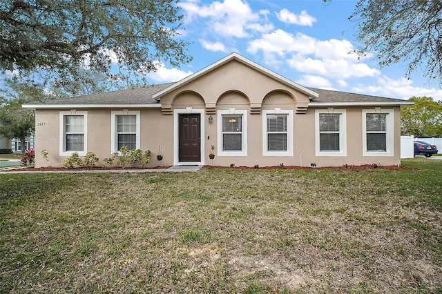 single story home featuring stucco siding, a shingled roof, and a front yard