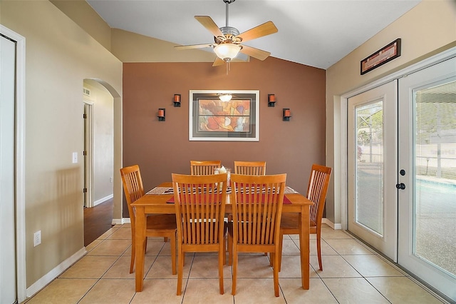 tiled dining area with vaulted ceiling, french doors, and ceiling fan