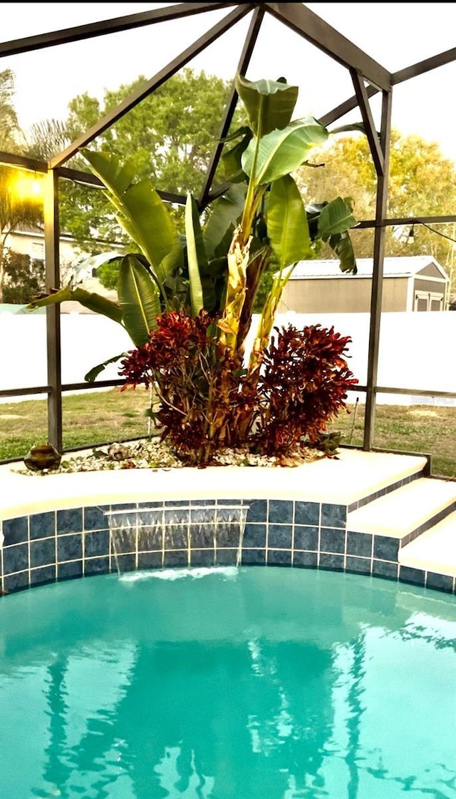 view of swimming pool with glass enclosure