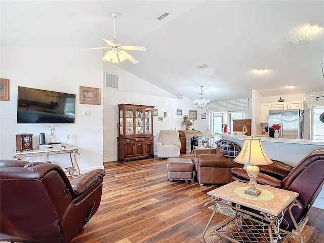 living room featuring hardwood / wood-style flooring, ceiling fan with notable chandelier, and high vaulted ceiling