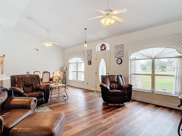 living room with lofted ceiling, a wealth of natural light, dark hardwood / wood-style floors, and ceiling fan