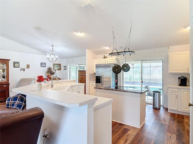 kitchen with sink, a kitchen island with sink, pendant lighting, and plenty of natural light