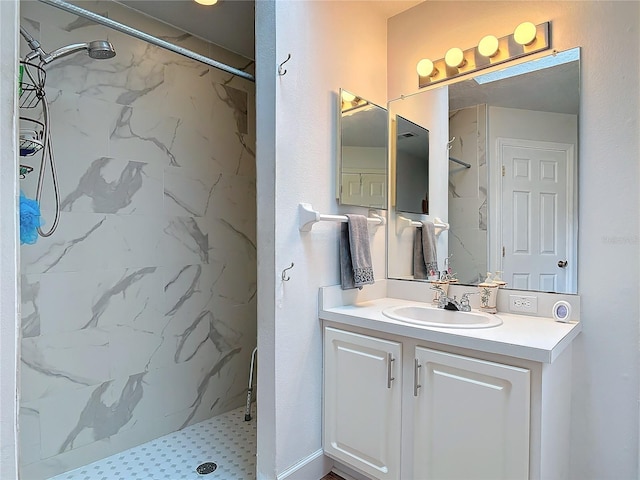 bathroom with vanity and a tile shower