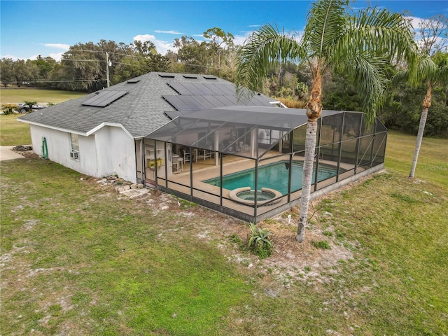 view of pool with an in ground hot tub, a lanai, a yard, and a patio area