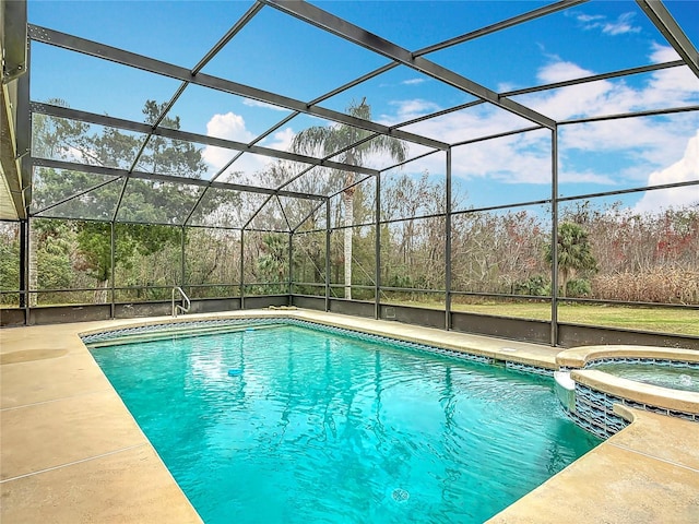 view of pool featuring an in ground hot tub, a patio, and glass enclosure