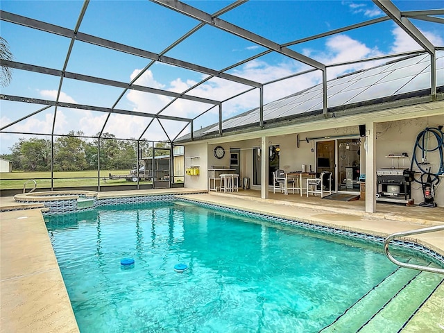 view of pool featuring a lanai, a patio area, an outdoor bar, and an in ground hot tub