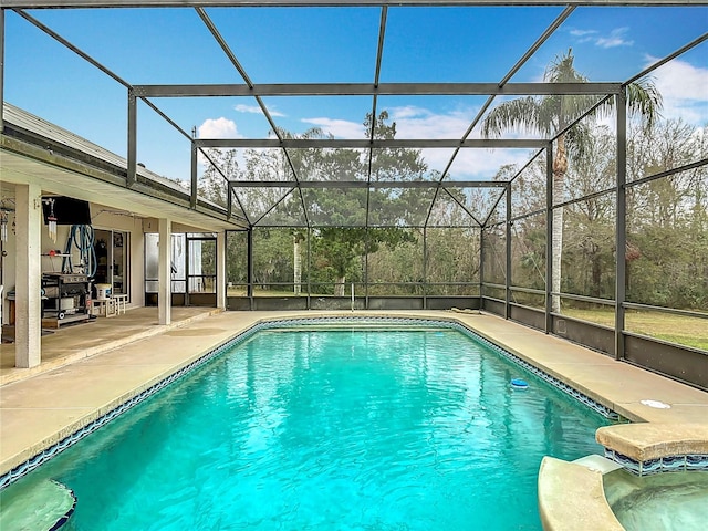 view of swimming pool featuring a patio and glass enclosure