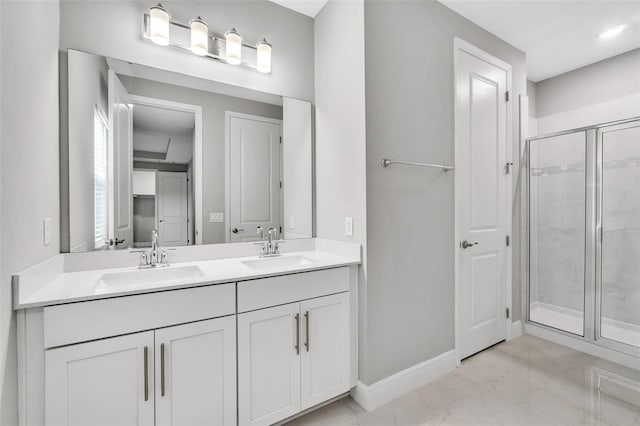 bathroom with vanity and a shower with door