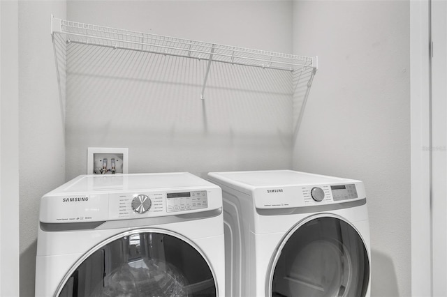 clothes washing area featuring independent washer and dryer