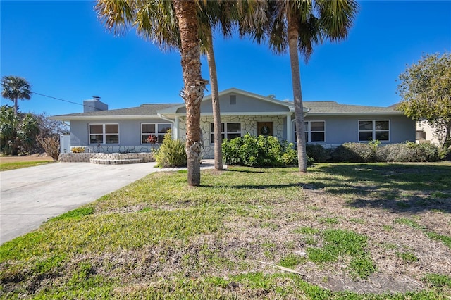 ranch-style home featuring a front yard