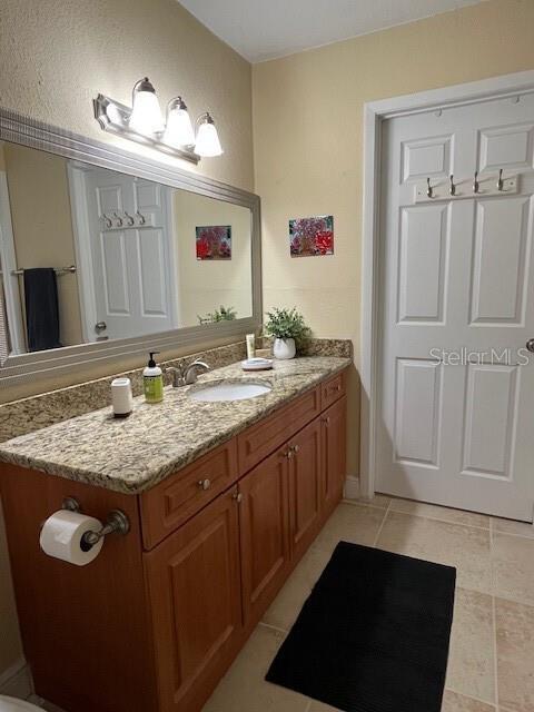 bathroom with tile patterned flooring and vanity