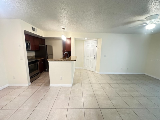 kitchen with sink, ceiling fan, appliances with stainless steel finishes, hanging light fixtures, and light tile patterned flooring