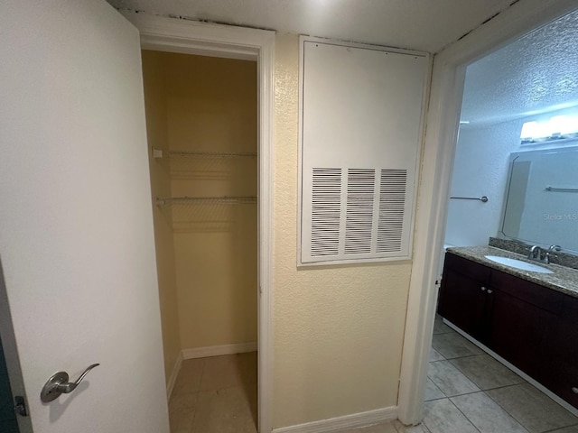 bathroom with tile patterned flooring and vanity