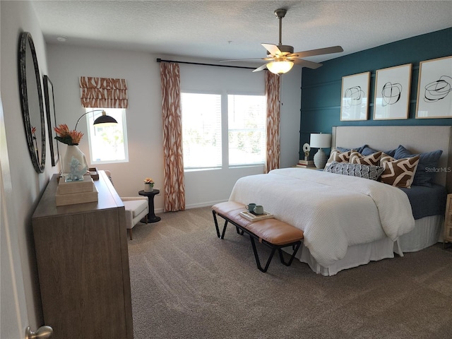 bedroom featuring light carpet, baseboards, a ceiling fan, and a textured ceiling